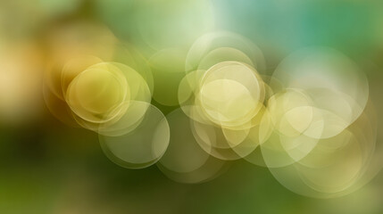 Soft bokeh effect with glowing circular yellow and green light spots creating a dreamy and abstract nature-inspired background ambiance
