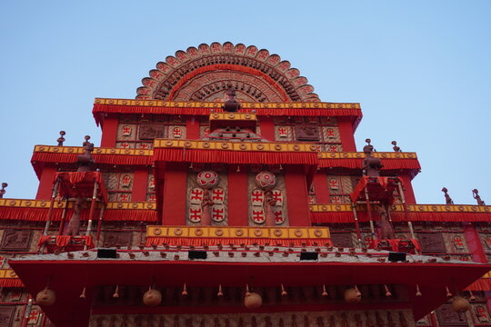 Intricate Red Temple Facade with Ornamental Columns and Arch Motif