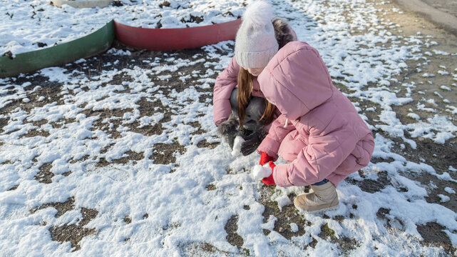 Two little girls playing on the playground on a winter day