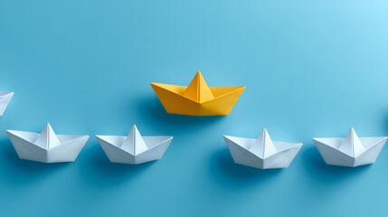 yellow origami boat among white boats on blue background