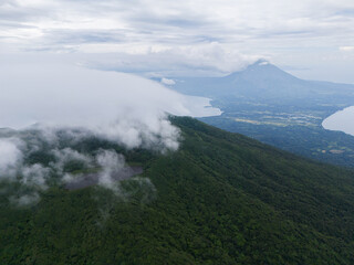 Panoramic view of lush mountains and tranquil lake under cloudy skies in El Salvador