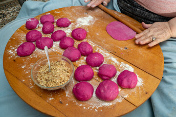 Woman hands making pastry. Colored bread dough making process.