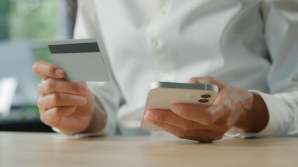 Unrecognizable business woman shopping with mobile phone and credit card unknown businesswoman female girl typing smartphone using online internet bank purchase service store order payment in office
