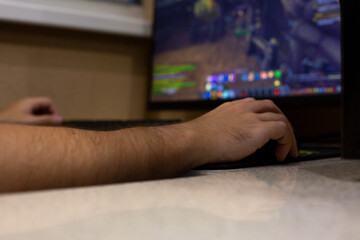Close up of person hand on gaming mouse, interacting with video game displayed on computer screen. The image focuses on gaming experience with vibrant colors and detailed in game elements