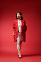 Confident young woman in bold red and white winter fashion against a bright backdrop