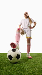 Confident female soccer player standing with foot on ball looking forward. Concept of motivation, leadership, sports coaching, and empowerment in media campaigns.