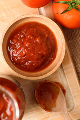 Tomato sauce for cooking Italian and Mediterranean food such as pasta and pizza, placed on a brown background