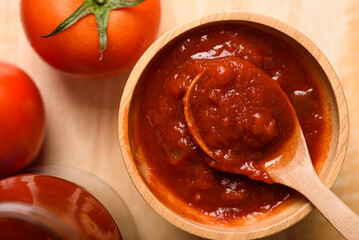 Tomato sauce for cooking Italian and Mediterranean food such as pasta and pizza, placed on a brown background