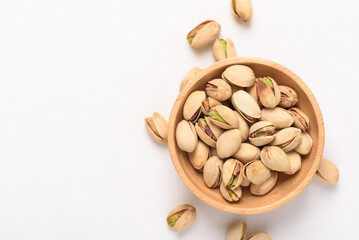 Roasted pistachios with salt, healthy snack on white background