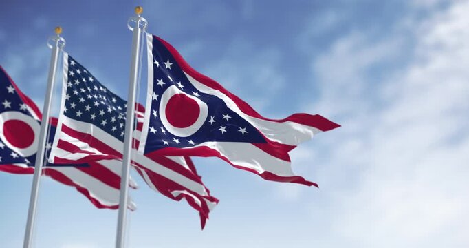 Ohio and national US flags waving in the wind on a clear day