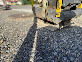 Piece of equipment is laying on the ground, with a yellow and black handle