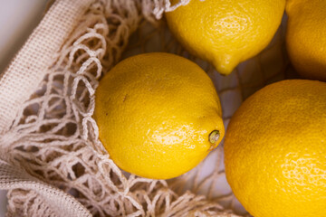 Trendy Net Bag with Lemons – Minimal Fashion Composition on White Background