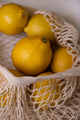 Yellow Lemons in Mesh Bag – Minimal Lifestyle Flat Lay on White Background