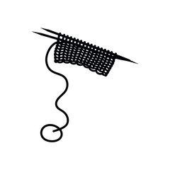 Knitted scarf slowly forming from needles