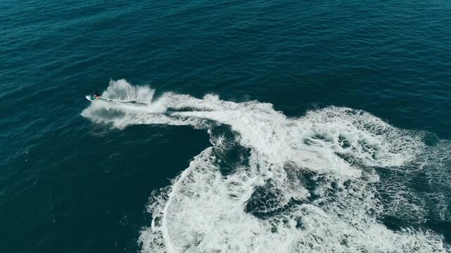 Drone shots of jetskies having fun riding waves