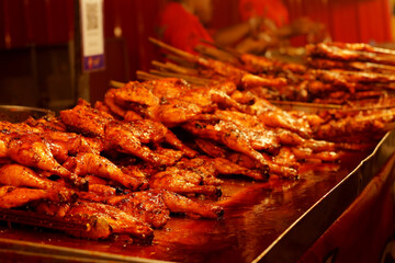 Several grilled chickens are being sold at the night market.