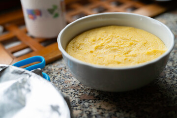 Bowl of yellow polenta on kitchen counter