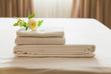 Towels and linens arranged neatly on a fresh table in a bright, inviting room