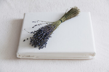 Dried lavender bouquet resting on a white fabric background in a calm setting