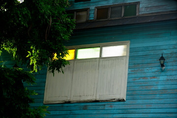 Colorful Windows on a Vintage Blue Wooden House Exterior