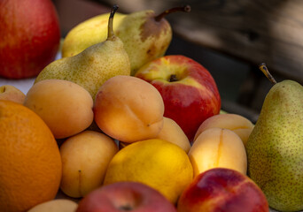 Apricots with apples and pears on a tray.