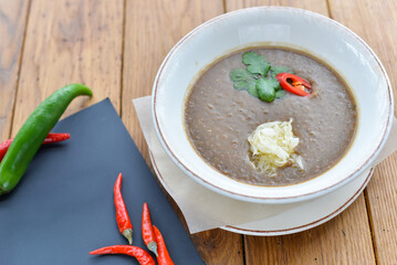 Mushroom cream soup in a white plate on a wooden table