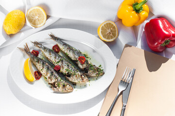 fried smelt fish grilled in a white plate