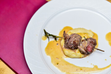 fried meat with mashed potatoes on a white plate