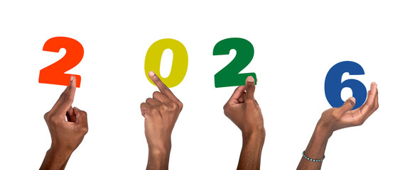 2026 new year celebration. Dark-skinned male hand raised with colorful numbers symbolizing festive