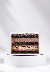Layered cake with black and orange colors on a display stand