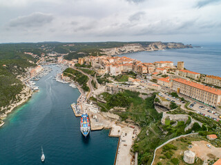 Aerial view marina cape Bonifacio south Corsica France citadel on rocky promontory on wild white limestone cliffs