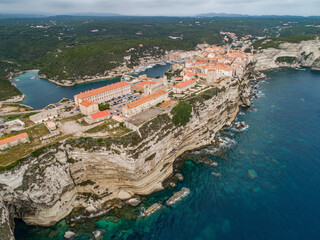 Aerial view marina cape Bonifacio south Corsica France citadel on rocky promontory on wild white limestone cliffs