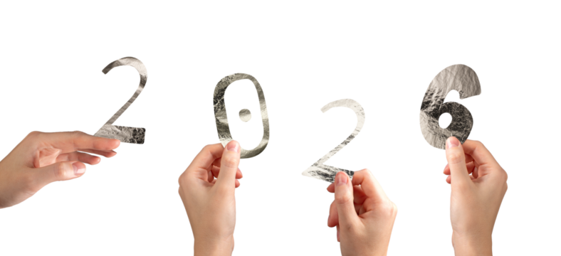 Hand holding silver metallic 2026 number in festive New Year celebration. Shiny textured foil
