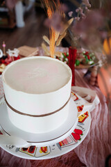 Baby shower setup with pastel balloons, cake and wrapped gifts on a cozy table, soft natural light and copy space—perfect for invitations and social posts.