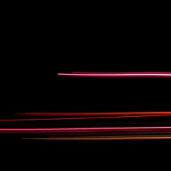 Abstract Light Trails in Neon Pink Red and Orange on Black Background