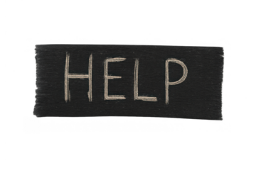 Help word written in chalk lettering on a black message board, needing urgent assistance or support concept