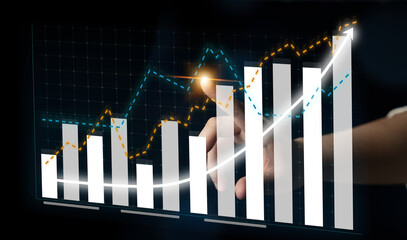 A digital interface depicting a hand interacting with bar charts and trend lines. This image symbolizes financial growth, data analysis, and insightful decision-making. Impute