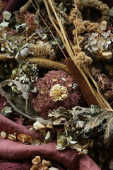 Different dry flowers on the wooden table