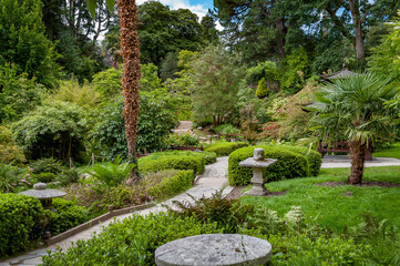 Japanese style garden with ponds, footpaths, small wooden bridges and lush green vegetation in Powerscourt gardens. Enniskerry, Wicklow, Ireland.