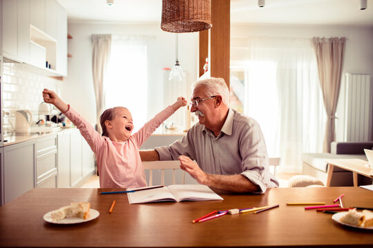 Grandfather and granddaughter enjoying time at home