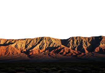 Majestic mountain range under a clear sky, illuminated by warm sunlight