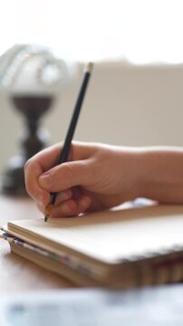 Young woman writing in notebook