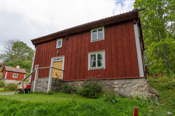 Fototapeta premium Traditional Red Wooden Swedish House in Countryside
