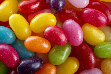A vibrant assortment of colorful jelly beans showcasing a variety of hues and glossy textures, creating a visually appealing and delicious candy display