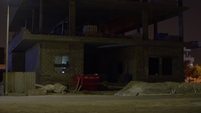 Apartment building under construction in Sar, Bahrain, night shot