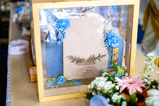 Elegant floral shadow box with blue accents perfect for wedding decor and special occasion gifts