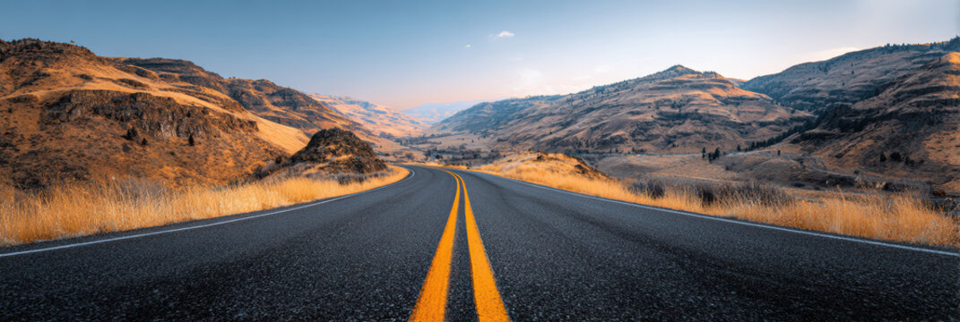 Scenic travel journey on an empty asphalt road and highway through mountain landscape. peaceful drive at sunset evokes feeling of adventure and absolute freedom