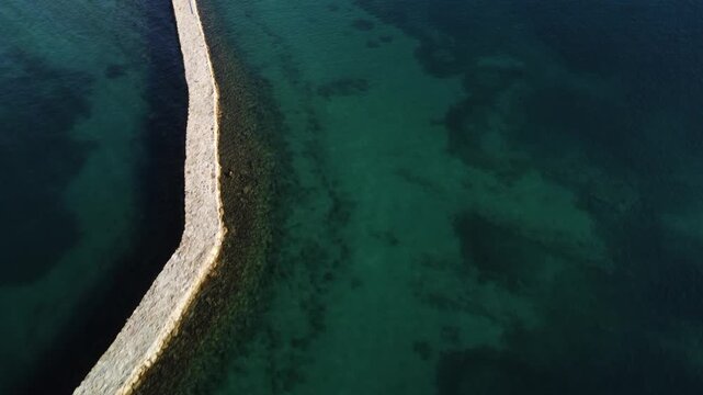 water polo field by the sea, by the concrete jetty, sunny day, summer, calm sea, view from a drone