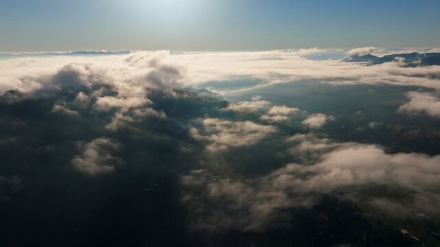 An Aerial View of Beautiful Clouds Over a Scenic Landscape Below