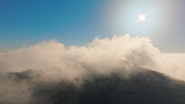 A Serene Mountain Landscape Featuring Fog Enhanced by Sunlight